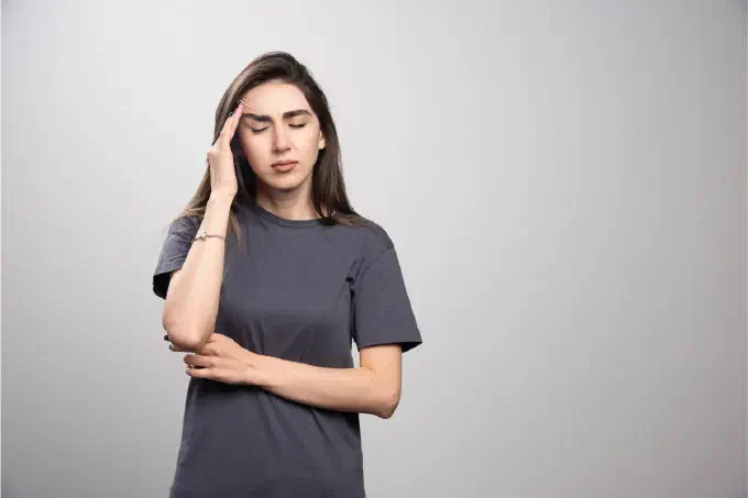 A girl is holding her head